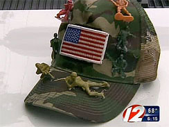 A hat with toy soldiers on it.  Because the soldiers have guns, and guns are prohibited by the school's weapons ban.