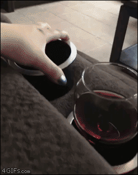 Caturday gif of a cat dumping a glass of wine on itself