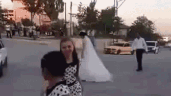 GIF of a car doing donuts around his bride