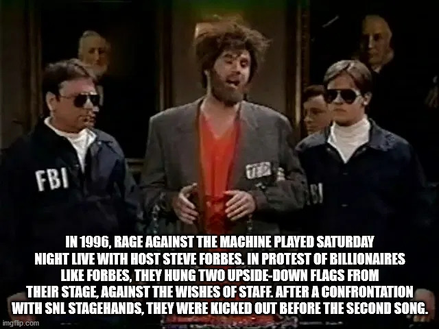 photo caption - wa Fbi In 1996, Rage Against The Machine Played Saturday Night Live With Host Steve Forbes. In Protest Of Billionaires Forbes, They Hung Two UpsideDown Flags From Their Stage, Against The Wishes Of Staff. After A Confrontation With Snl Sta