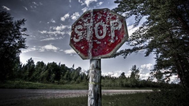 stop sign with bullet holes