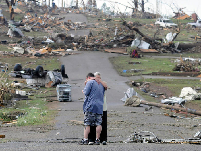 A mother comforts her son following the 2011 tornado in Concord, Alabama.
