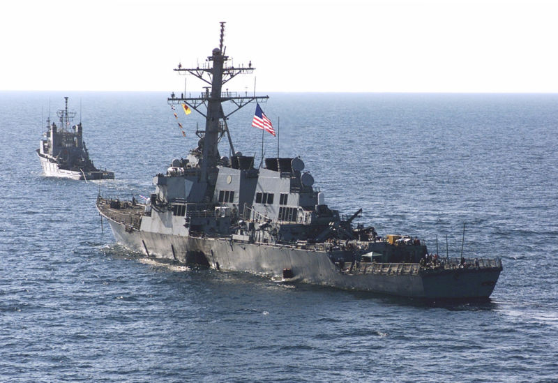 USS Cole limps out of the Port of Aden, Yemen after being struck by a small boat laden with explosives. Seventeen sailors lost their lives that day.