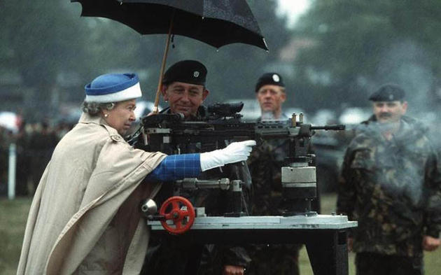 Queen Elizabeth II firing a British L85 battle rifle. Surrey, England,1993.