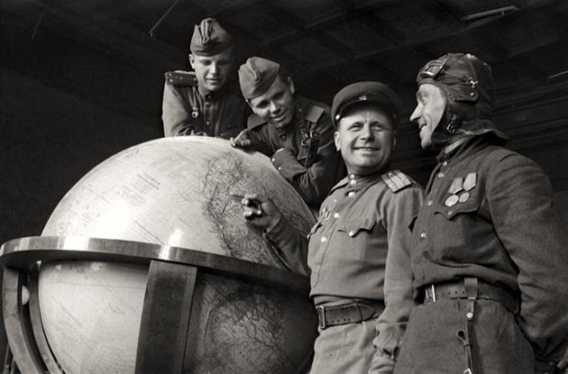 Soviet soldiers pose with 'Hitler's Globe'. Berlin, Germany, 1945.