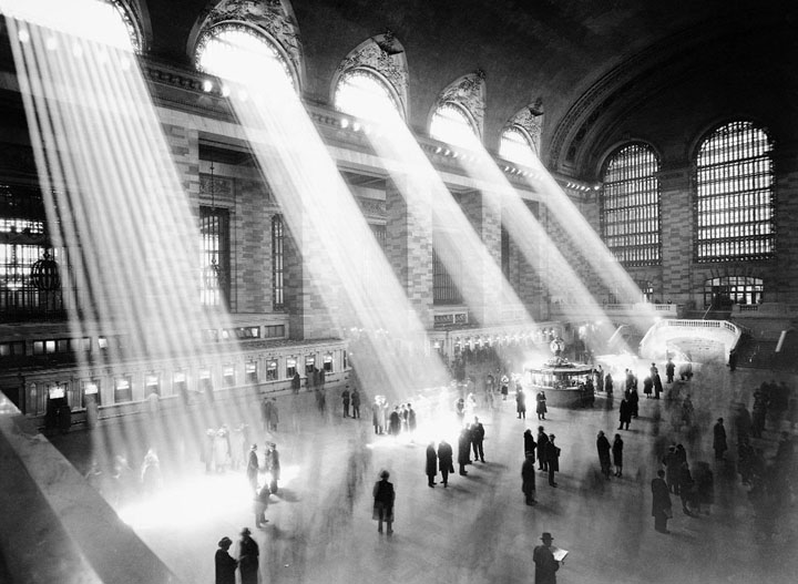 Sunlight floods in through windows in the vaulted main room of New York City's Grand Central Terminal, illuminating the main concourse, ticket windows and information kiosk. Photo taken ca. 1935-1941.
