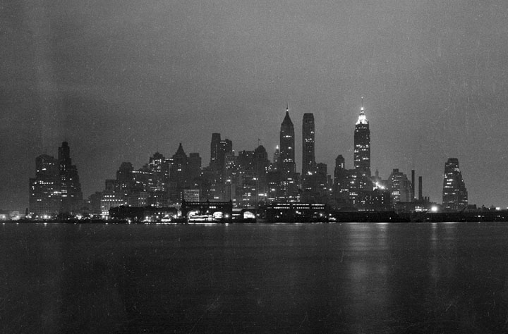 Lower Manhattan skyline at night, seen from either the Staten Island Ferry or Governor's Island, in February of 1938.