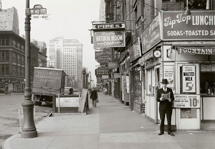 A man reads a newspaper on New York's 6th Ave. and 40th St, with the headline: "Nazi Army Now 75 Miles From Paris.", on May 18, 1940.