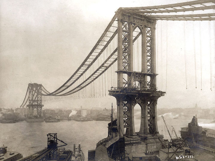 Manhattan Bridge, under-construction, seen from the roof of Robert Gair Building, showing suspenders and saddles, on February 11, 1909.