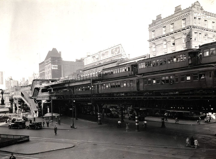 Ninth Avenue El trains with passengers on 2 levels of tracks, 66th Street El station in background, in October of 1933. Photo taken on Columbus Avenue, northwest of Lincoln Square  65th Street.