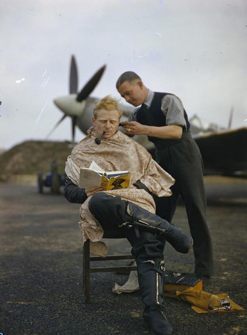 An Royal Air Force pilot getting a haircut during a break between missions, Britain, 1942