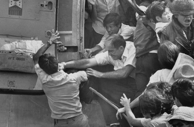Evacuating Saigon, April 30, 1975. An American evacuee punches away a South Vietnamese man for a place on the last chopper out of the US embassy.
