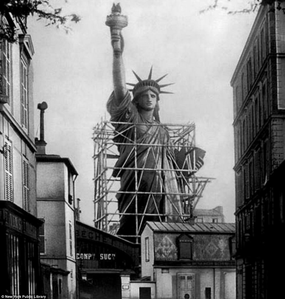 The Statue of Liberty surrounded by scaffolding as workers complete the final stages in Paris. Circa 1885.
