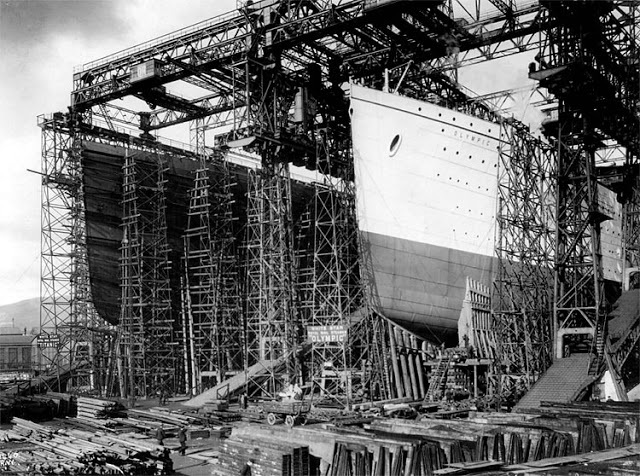 The hulls of the RMS Titanic, left, and of her sister ship, the RMS Olympic, are surrounded by construction scaffolding at a shipyard in Belfast, Northern Ireland. The New York Times