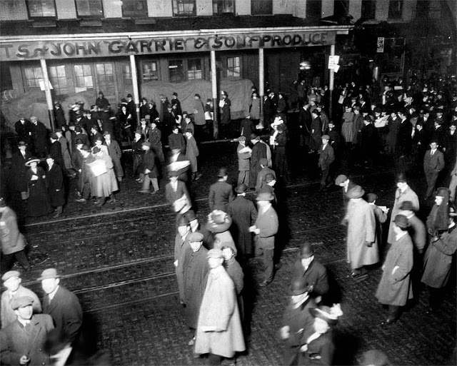 People gather in New York to await the arrival of survivors of the sinking of the RMS Titanic aboard the RMS Carpathia on April 18, 1912. The New York Times