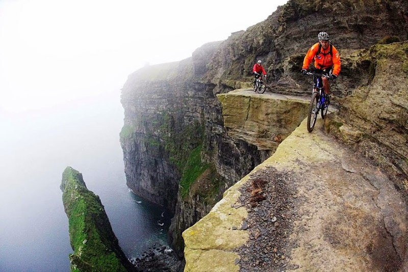1. The Cliffs of Moher, Ireland Mountain bikers ride along the Cliffs of Moher in Ireland, known as one of the most terrifying bike paths in the world.