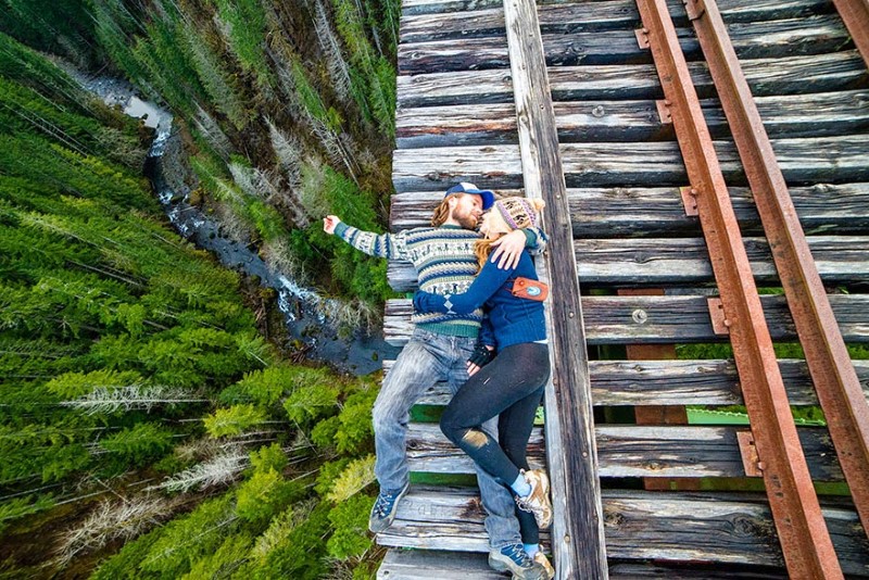 11. A Railroad Track in Washington, USA A couple shows no fear as the lay on a railroad track inches away from plummeting into the forest below.