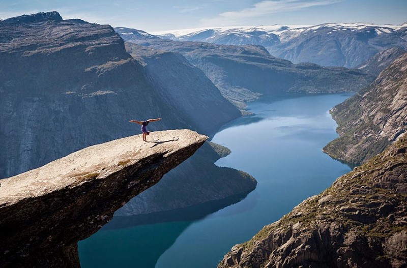 12. Trolltunga, Norway A women poses on Trolltunga, a piece of rock hanging out 2,300 feet above Lake Ringedalsvatnet in Norway.
