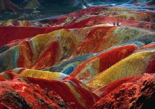 This is a unique geological phenomenon known as Danxia landform. These phenomena can be observed in several places in China. This example is located in Zhangye, Province of Gansu. The color is the result of an accumulation for millions of years of red sandstone and other rocks.