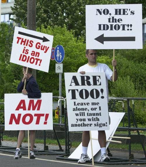 funny sign boards - No, He's the Idiot! This Guy is an Idiot! Are Too! Am Not! Leave me alone, or I will taunt you with another sign!
