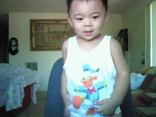 gifs - baby picks up his shirt in front of the camera