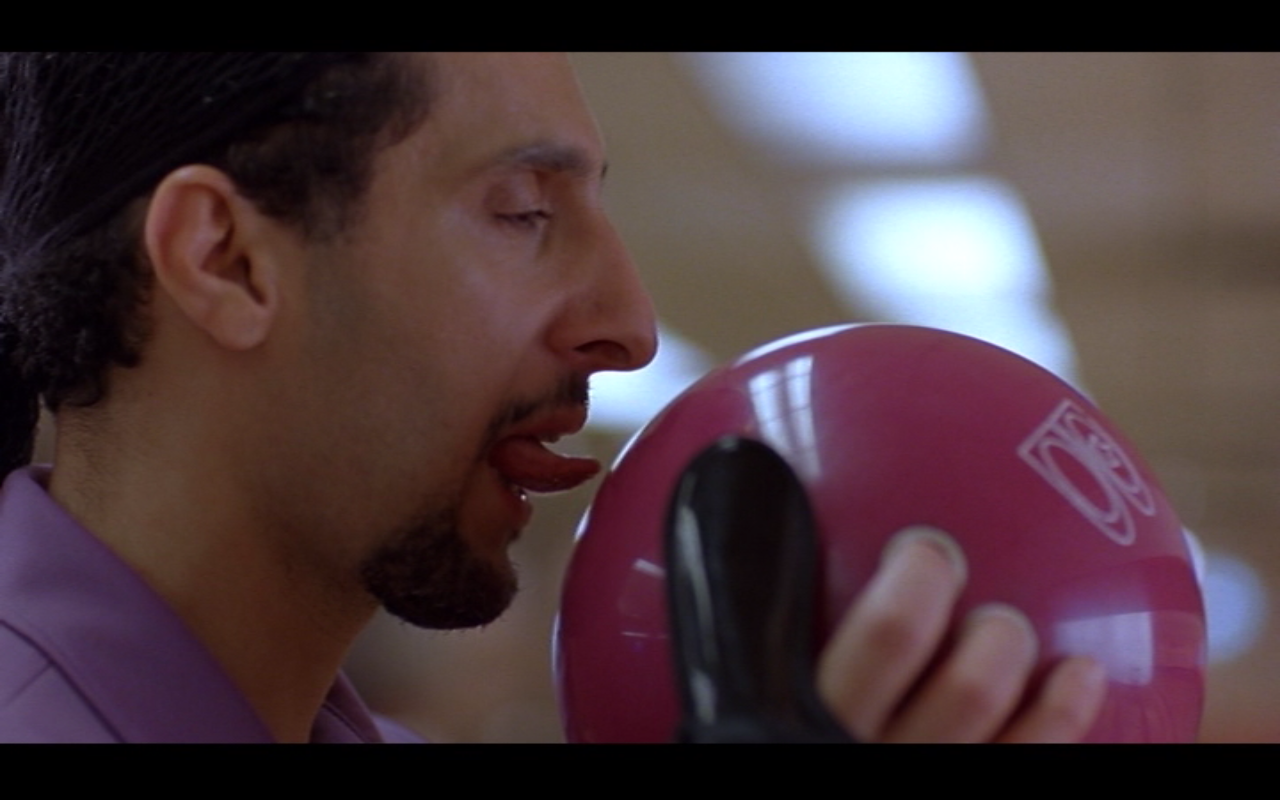 When the John Turturro's character Jesus has to go door to door, sharing that he is a convicted sex offender, he has a large bulge in his tight pants. The bulge was formed by a bag of birdseed.