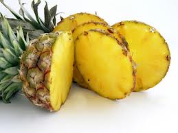 Pineapples stop ripening the minute they are picked. No special way of storing them will help ripen them further. Colour is relatively unimportant in determining ripeness. Choose your pineapple by smell.  If it smells fresh, tropical and sweet, it will be a good fruit.