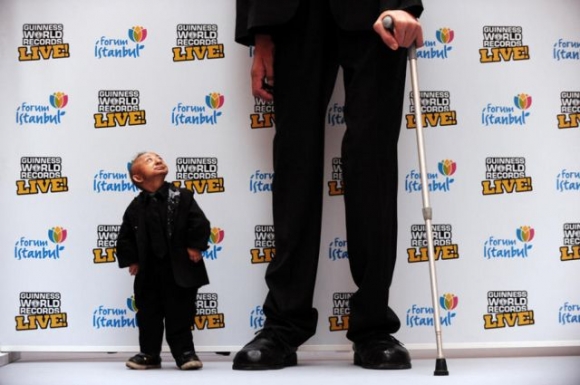The worlds smallest person finally meets the worlds tallest.. "Can i have a ladder please?"  
