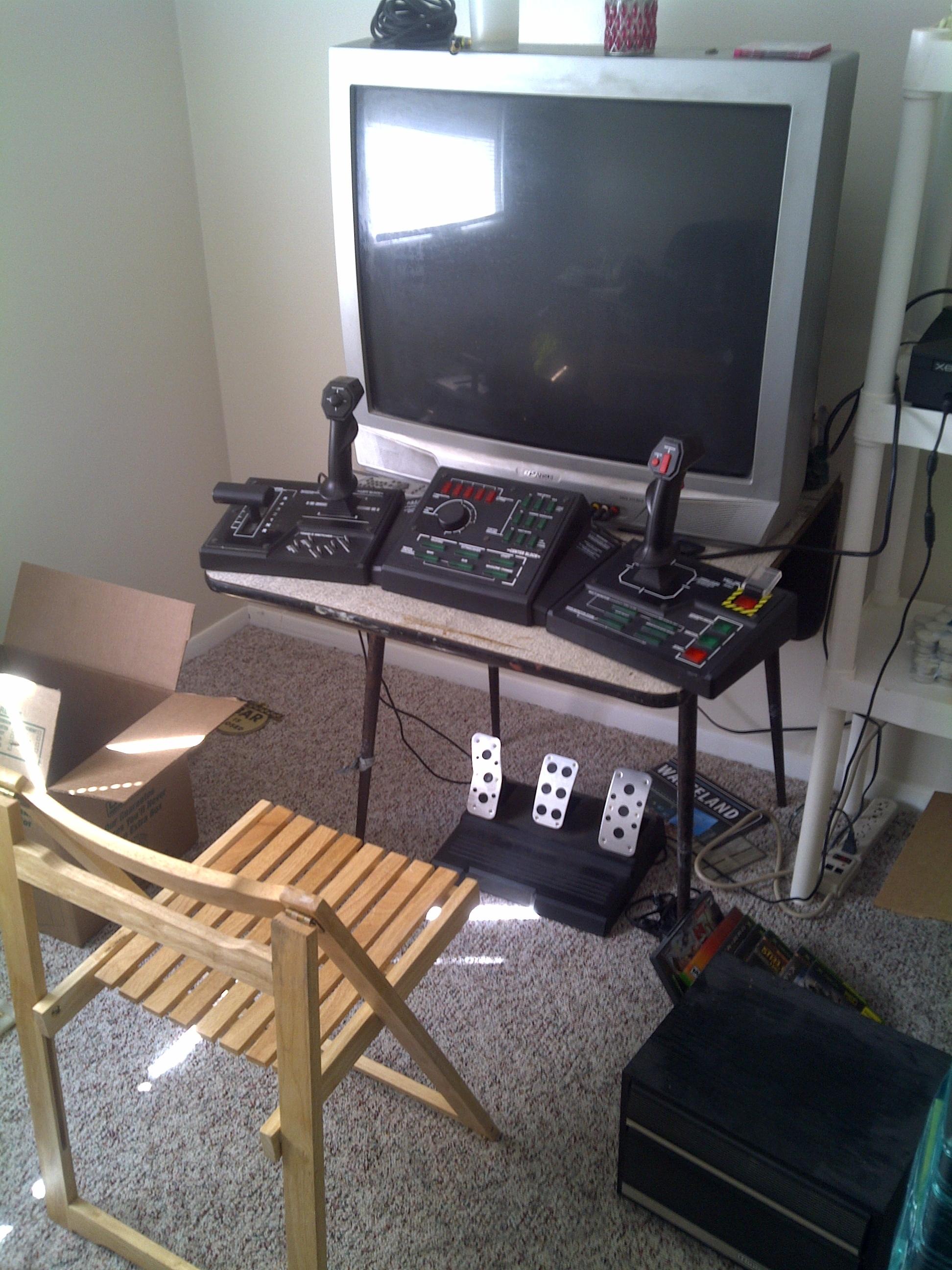 This seems like the setup of someone who enjoys playing flight sims and flight combat games.  Dual joysticks - Check.  Gas/Brake and Rudder Control Pedals - Check.  Old AF CRT TV sitting on top of a flimsy ass fold-able table - Check mate.
