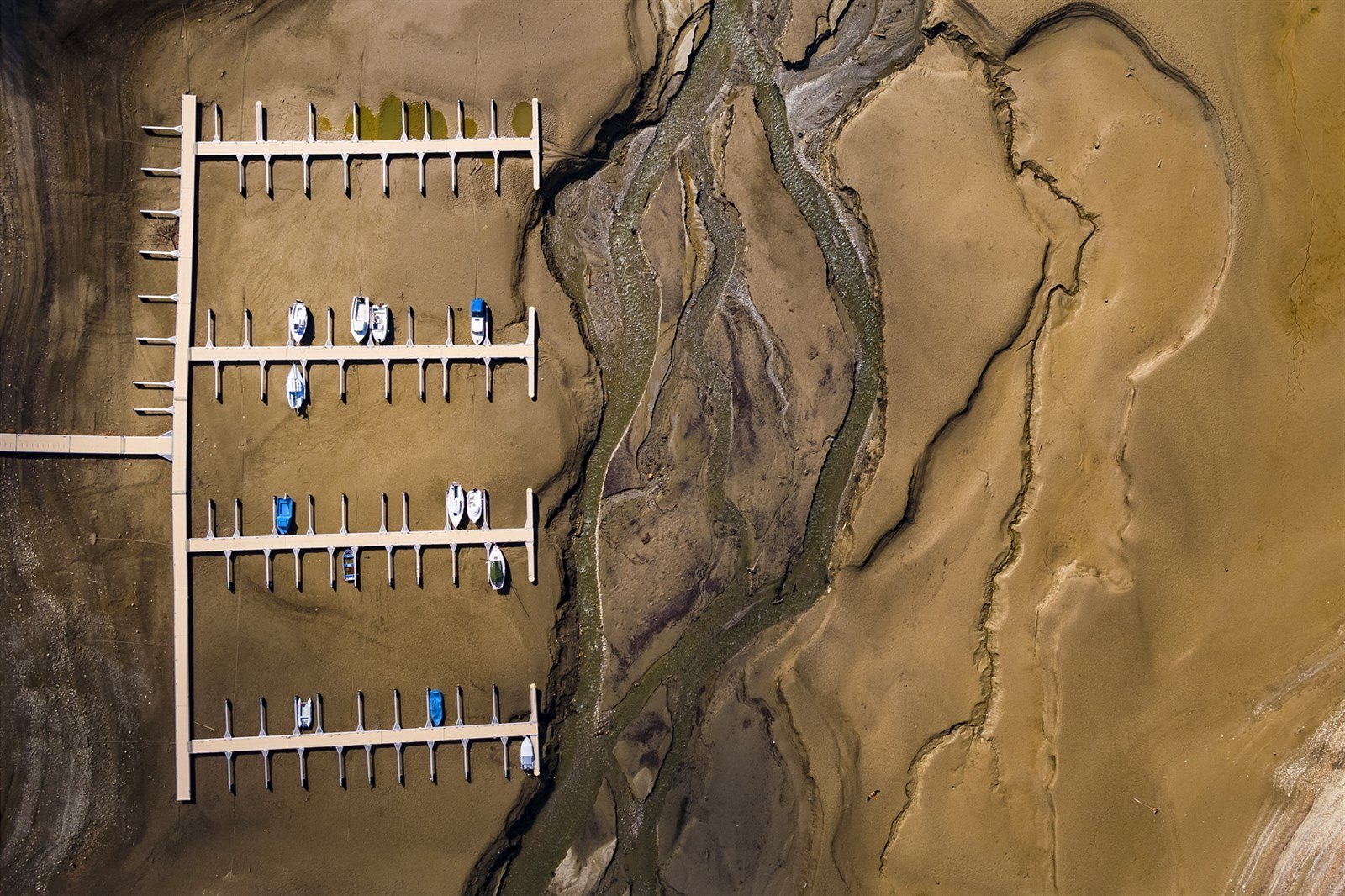 The tide is out - sorta - boats stranded in Lake Gruyere, Switzerland, drained anticipating a heavy snowmelt.  Photo by Valentin Flauraud