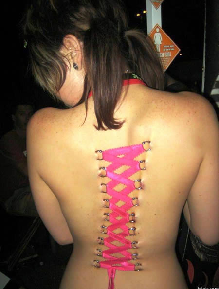 Corset Piercing;
Two rows of piercings run down the back, and then a piece of ribbon is threaded through them. This duplicates the look of the ties on a corset, which has definite aesthetic appeal.