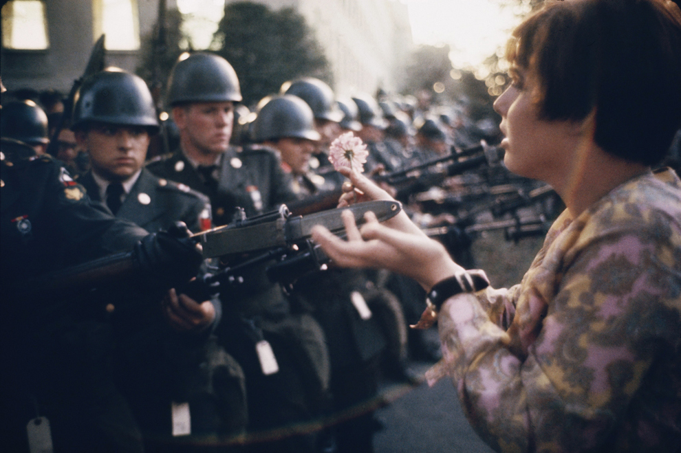 “La Jeune Fille a la Fleur,” a photograph by Marc Riboud, shows the young pacifist Jane Rose Kasmir planting a flower on the bayonets of guards at the Pentagon during a protest against the Vietnam War on October 21, 1967. The photograph would eventually become the symbol of the flower power movement.