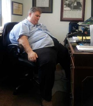 Obese Man Sleeping at his desk.