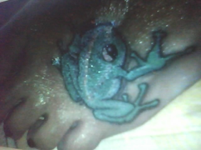 frog tattoo on black chick foot