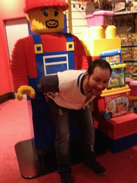 Giant Legoman using casual passers by.