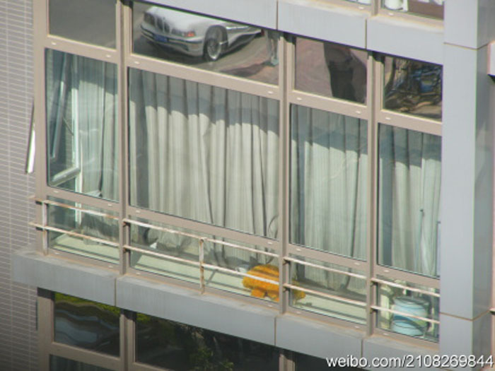 Nude Chinese woman sunbathing in the window
