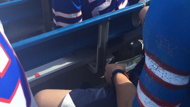 Can you spot what this Buffalo Bills fan is doing?