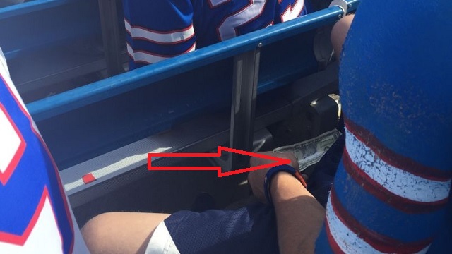 Can you spot what this Buffalo Bills fan is doing?