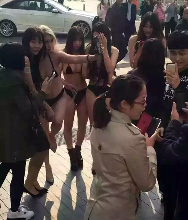 Bikini wearing Beijing girls with barcodes on their butts.