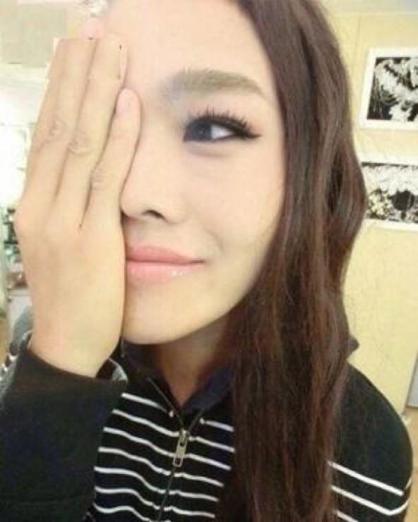A cute girl covering half her face...