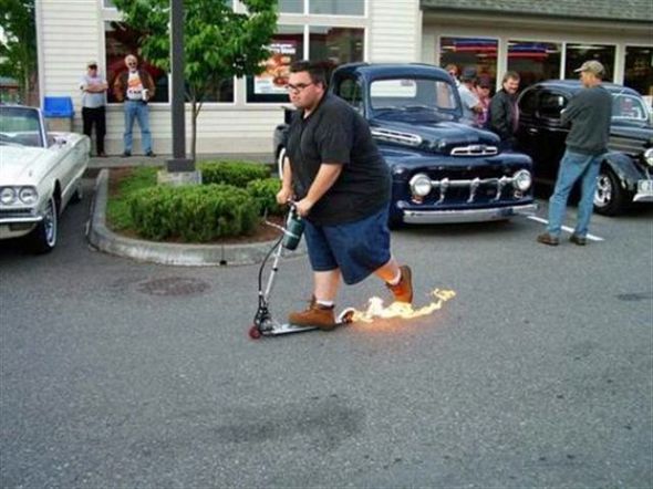 Fat guy burns out on a scooter 