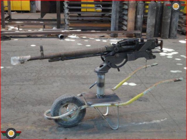 Look at this contraption.  A high caliber gun mounted to a wheelbarrow.  