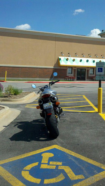 In case you can't quite make it out...that is a handicap sign on the license plate of that motorcycle.  Seriously...wtf?