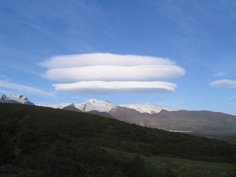Lenticular Clouds: stationary lens-shaped clouds that form at high altitudes, normally aligned perpendicular to the wind direction.