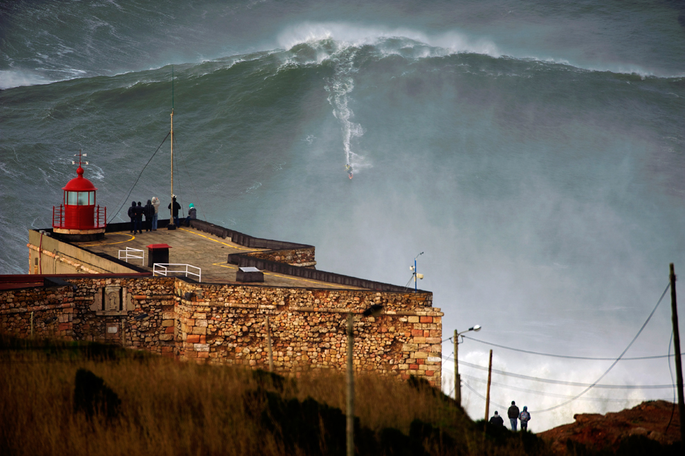 Garrett McNamara rides a 100-ft wave off Praia do Norte beach in Nazare, Portugal