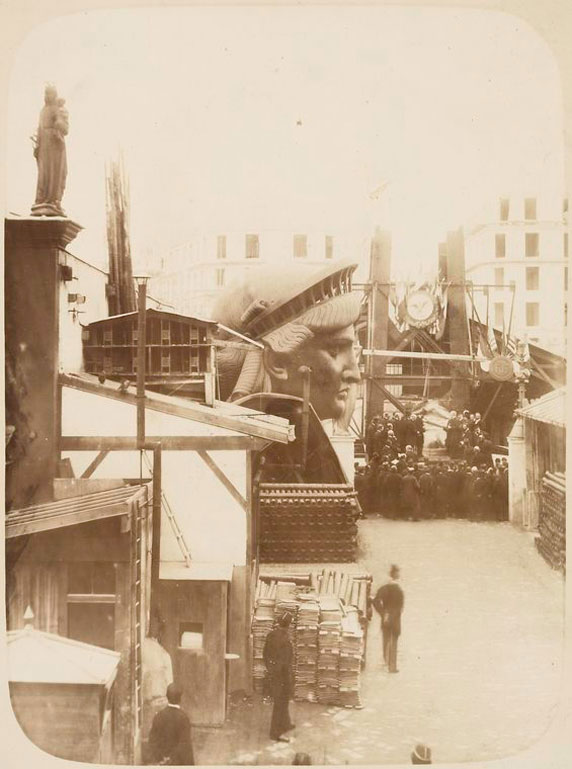 The external area of the workshop in Paris, including construction materials and the Statue head