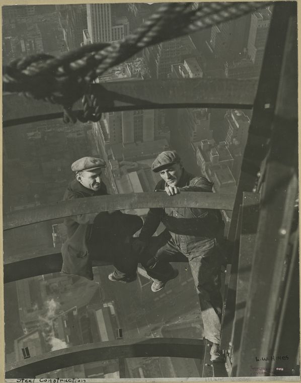 Two workers inspecting steel