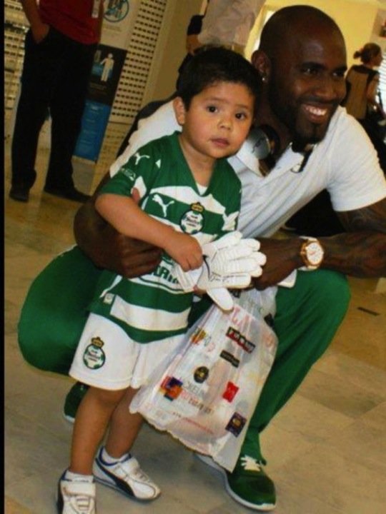 Soccer player takes a photo with a young fan after he exits the adult store.
