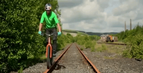 people are awesome gif biker jumping on train tracks