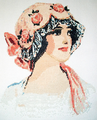 Cross stitch picture of a Victorian lady.